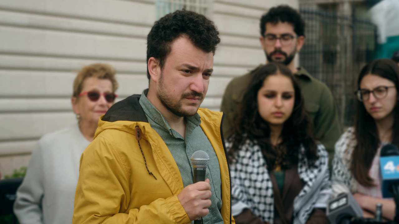 a man with a beard holding a microphone